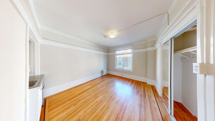 A room with wooden floors and white walls.